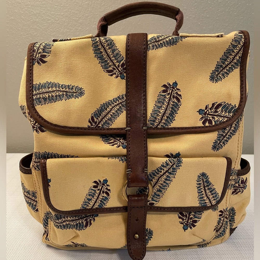 “Lucky” Twill back pack. Mustard color w/feather design & brown leather trim.